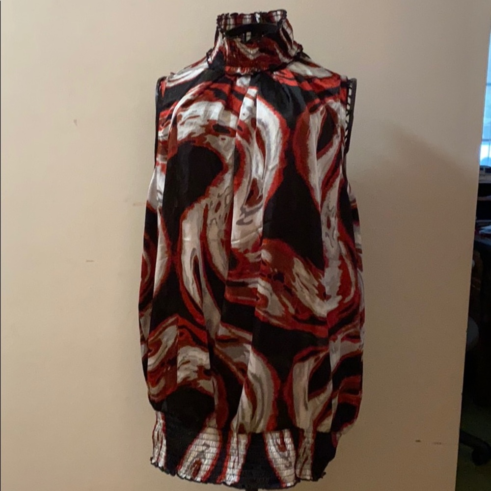 Red, black and white patterned top.